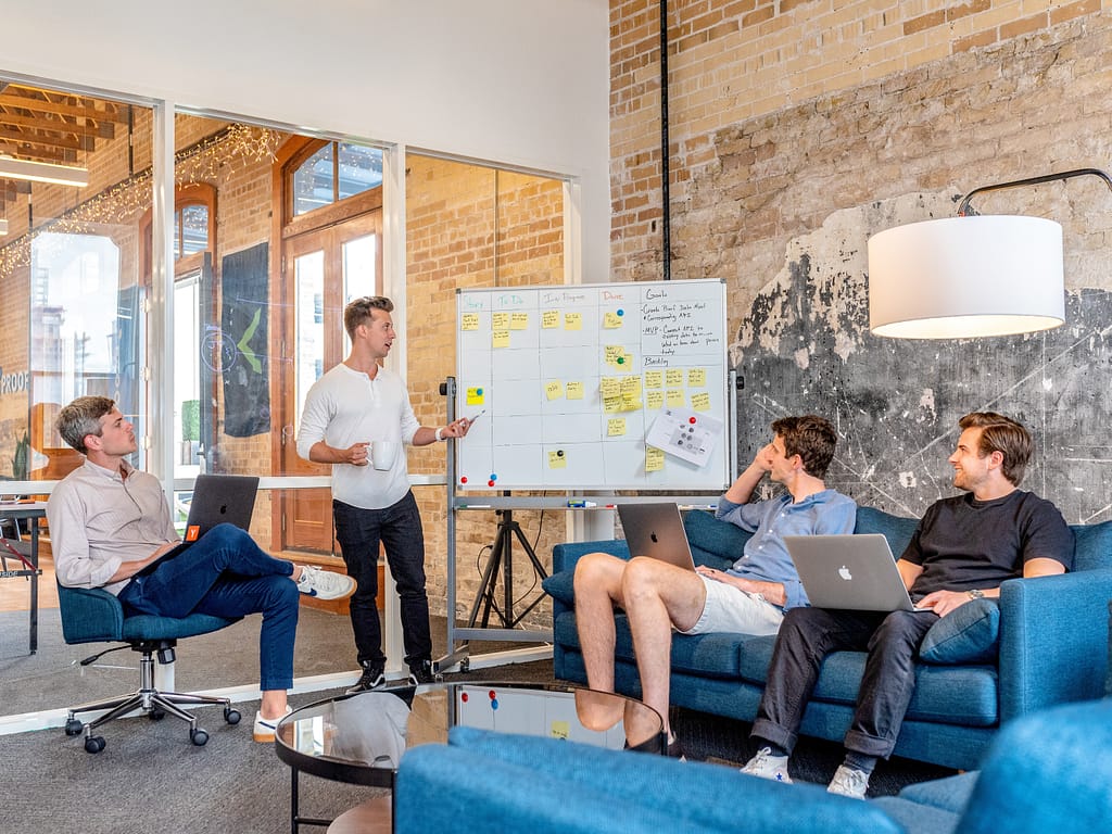 Team working on a whiteboard creating a brand strategy